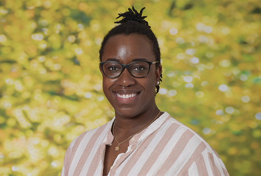 A picture of Tiye Cort Odima outside and smiling for the camera.