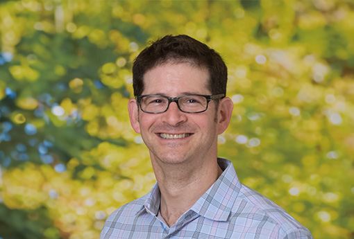 A picture of Michael Himelfarb outside and smiling for the camera.